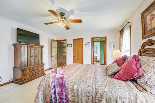 a bedroom with a bed and a ceiling fan at 18 Mi to Table Rock Lake Pet-Friendly Ozark Home! in Omaha