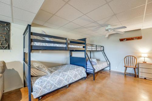 a bedroom with two bunk beds and a ceiling fan at 18 Mi to Table Rock Lake Pet-Friendly Ozark Home! in Omaha