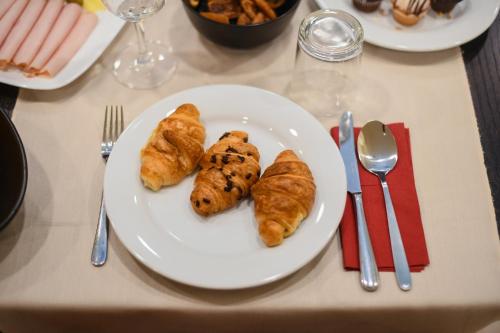 a white plate with pastries on a table at Hotel PARK 45 in Zagreb