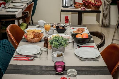 a table with plates and bowls of food on it at Hotel PARK 45 in Zagreb