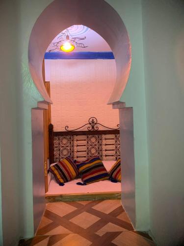 a room with a bed with two pillows on it at Blue heart in Chefchaouen