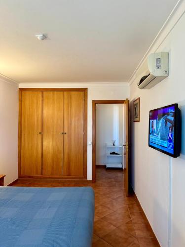 a bedroom with a bed and a tv on a wall at Grupo Morgado - Quinta do Morgado - Morgado Privilege in Tavira