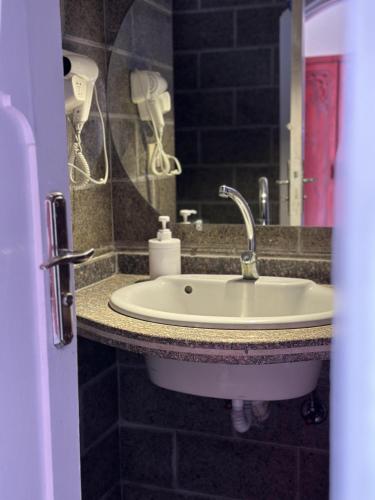 a bathroom with a sink and a mirror at Ali Baba Hotel in Dahab