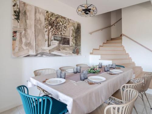 a dining room with a table and chairs and stairs at Villa Althea 1 in Kompítsion