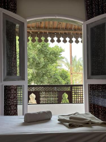 an open window with a view of a garden outside at Ali Baba Hotel in Dahab