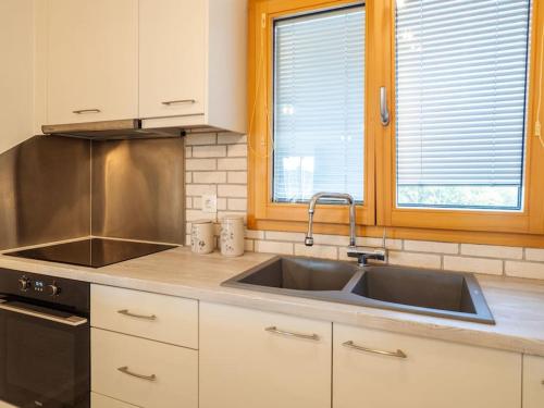 a kitchen with a sink and a stove at Villa Althea 1 in Kompítsion