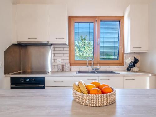 a kitchen with a bowl of oranges on a counter at Villa Althea 1 in Kompítsion