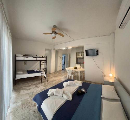 a bedroom with a bed and a room with two bunk beds at Villa Katia in Asprovalta