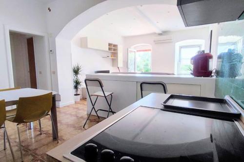 Casa Arcobaleno - giardino e parcheggio gratuito في لا سبيتسيا: مطبخ مع طاولة وكراسي في الغرفة