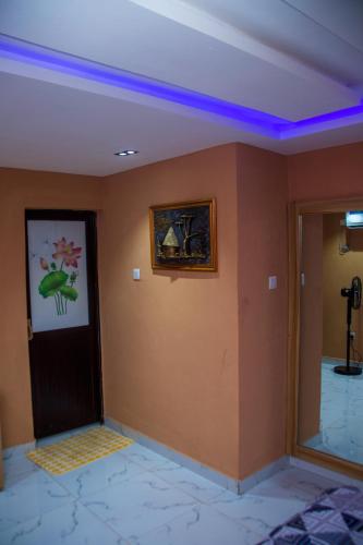 a room with a door and a painting on the wall at draysapartments in Ibadan