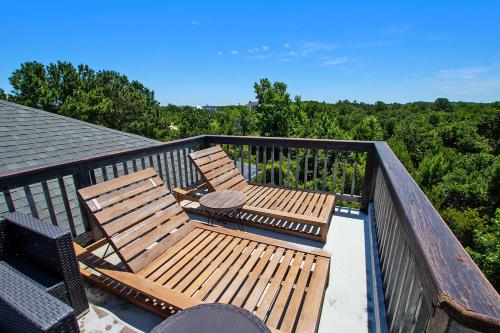a balcony with two wooden chairs and a view of trees at Soundside, Canal Front! Water views!, 4x535, The 4x4 Leaf Clover in Knotts Island