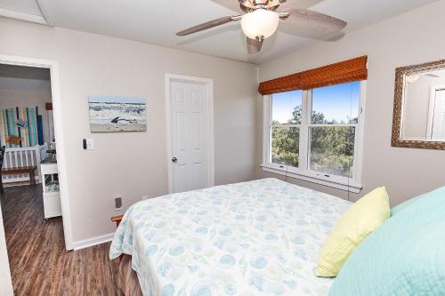 a bedroom with a bed and a ceiling fan at Soundside, Canal Front! Water views!, 4x535, The 4x4 Leaf Clover in Knotts Island