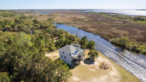 an aerial view of a house next to a river at Soundside, Canal Front! Water views!, 4x535, The 4x4 Leaf Clover in Knotts Island