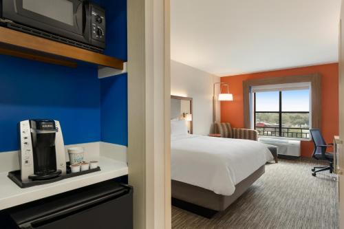 a hotel room with a bed and a television at Holiday Inn Express Hotel & Suites Mount Pleasant - Charleston by IHG in Charleston