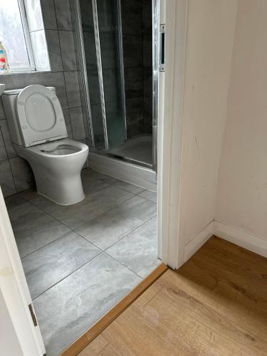 a bathroom with a toilet and a shower at Double Room With Free WiFi Keedonwood Road in Bromley