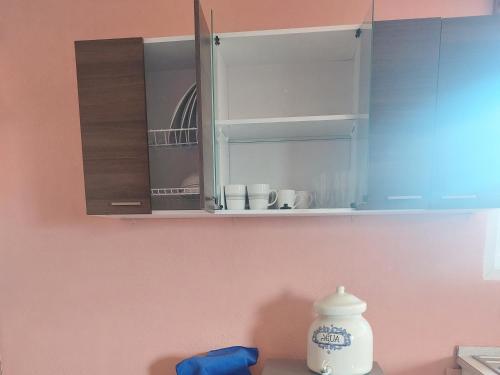 a kitchen with white cabinets and a counter top at casamares - casanon in San José Pinula