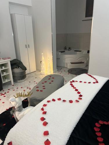 a room with a bed with red hearts on it at Eleutheria in Gravina di Catania
