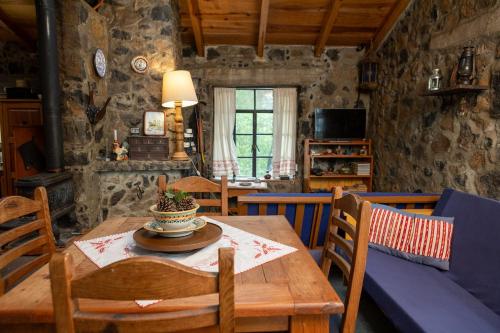 a dining room with a wooden table and chairs at Hermosa cabaña en el bosque in Tres Marías