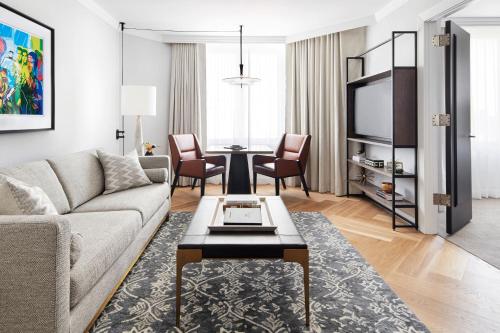 a living room with a couch and a table at The Luxury Collection Hotel Manhattan Midtown in New York