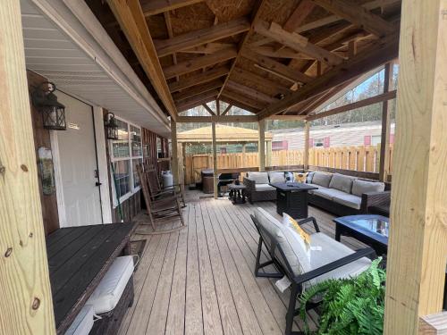 an outdoor deck with couches and tables and chairs at The Eagles Nest in London