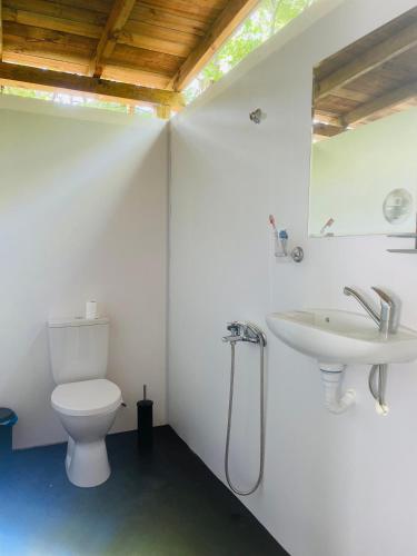 a bathroom with a toilet and a sink at Каравана Безвремие in Chernomorets