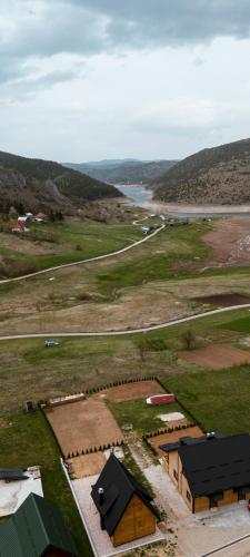 an overhead view of a field with buildings and a road at Vila Biser Uvca i Zlatara in Nova Varoš