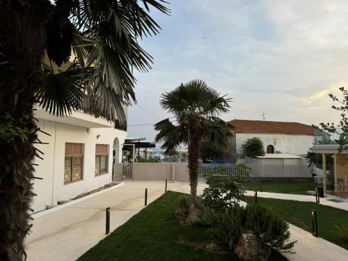 a house with a palm tree in the yard at Studio Nikiti Beach in Nikiti