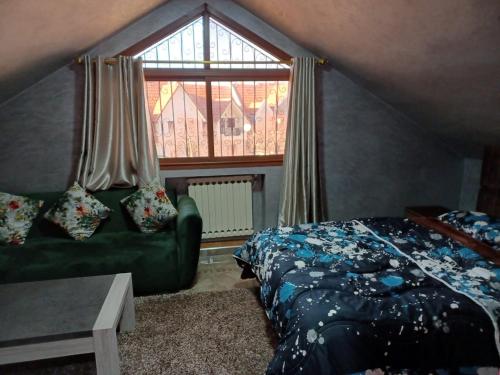 a bedroom with a green bed and a window at Lovely & Cozy Self-Contained Studio Apartment For 2 Guests Apt No 4 in Ifrane