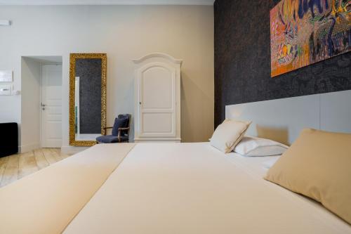 a bedroom with a large bed and a blue chair at It's Room Naples in Naples