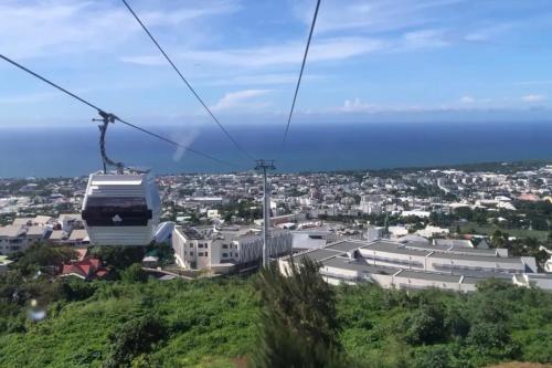 a gondola ride in the sky over a city at DUPLEX BOUGUAINVILLIER in Saint-Denis
