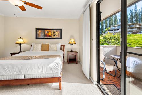 a bedroom with a bed and a balcony at Kapalua Golf Villa 20V 1 in Kahana