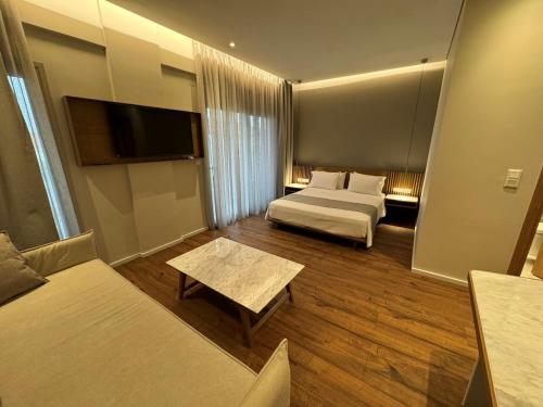 a hotel room with two beds and a tv at Studio Nikiti Beach in Nikiti