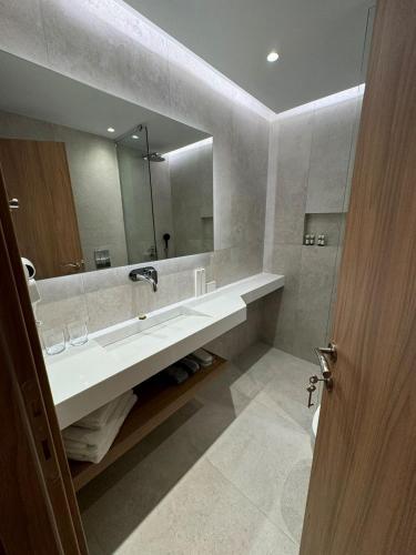 a bathroom with a sink and a large mirror at Studio Nikiti Beach in Nikiti