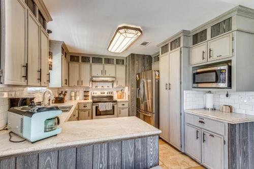 a kitchen with white cabinets and a blue appliance at Waterfront Florida Vacation Rental with Boat Dock in Milton