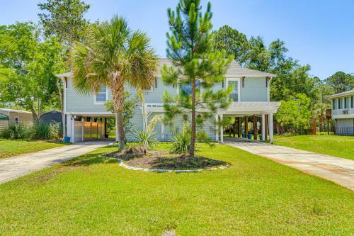 a house with palm trees in the front yard at Waterfront Florida Vacation Rental with Boat Dock in Milton