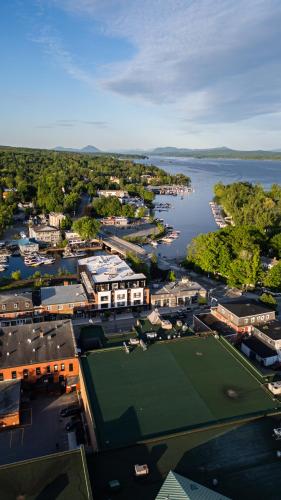 an aerial view of a city with a tennis court at Hôtel Expérience - Quartier Des Marinas in Magog-Orford