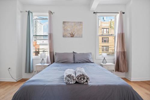 a bedroom with a bed with two pillows on it at Modern Home 4BR 3BA - 20 Min to Timesquare in Jersey City