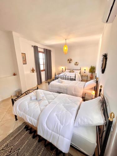 a bedroom with two beds in a room at Dar Bakkali Nadi in Tangier