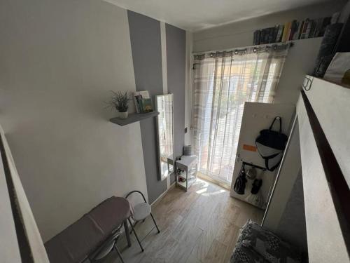 un salon avec un canapé, des chaises et une fenêtre dans l'établissement Petit studio de charme, à Villefranche-sur-Mer