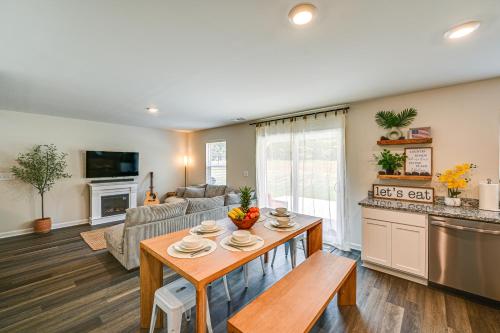 a living room with a table and a kitchen at Modern Anderson Home with Fire Pit and Grill in Anderson