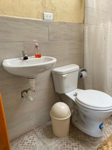 a bathroom with a toilet and a sink at Casa Hotel Loma Wasi en Cotacachi in Cotacachi