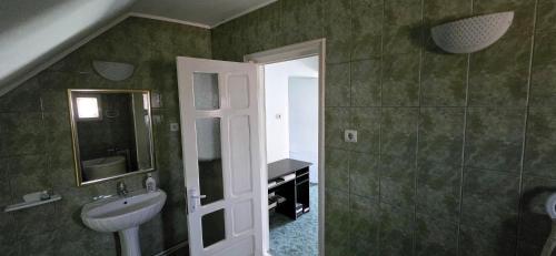 a bathroom with a sink and a mirror at La mama Miha in Agigea