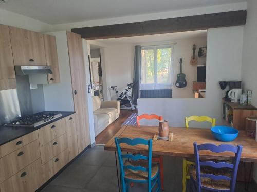 a kitchen with a table and chairs in a room at Sous les tilleuls in Saint-Brevin-les-Pins