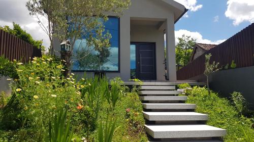 a house with stairs in front of a garden at CASA ANJOS in Amarante
