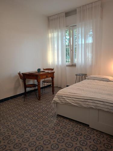 a bedroom with a bed and a desk next to a window at Bblueb&b in Rimini