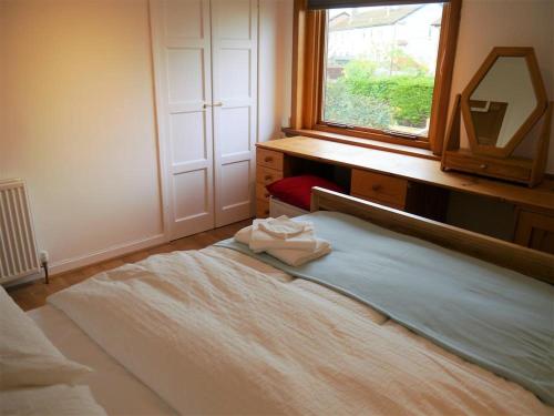 a bedroom with a bed with a mirror and a window at Twenty DC in Edinburgh
