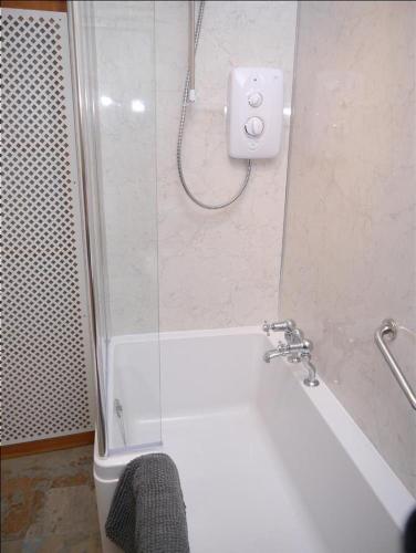 a bathroom with a shower and a white bath tub at Twenty DC in Edinburgh