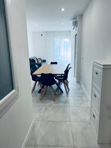 a kitchen and dining room with a table and chairs at MK Apartments in Lido di Jesolo