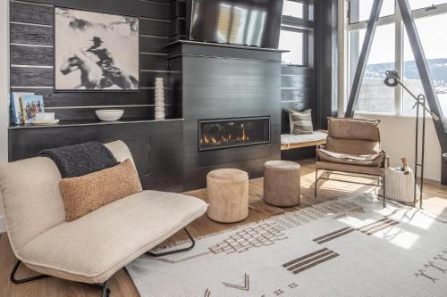 a living room with a couch and a fireplace at Fairways #2 in Big Sky