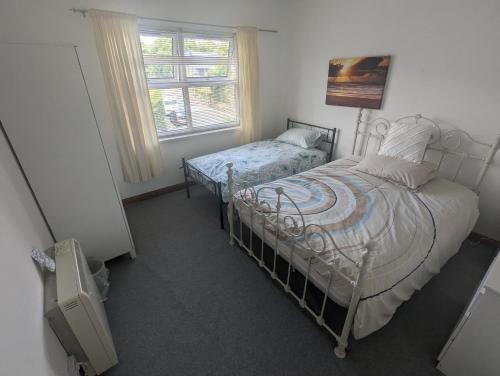 a bedroom with a twin bed and a window at The Apartment at Chalk House - 3 Beds - 1 Cot in Lindley